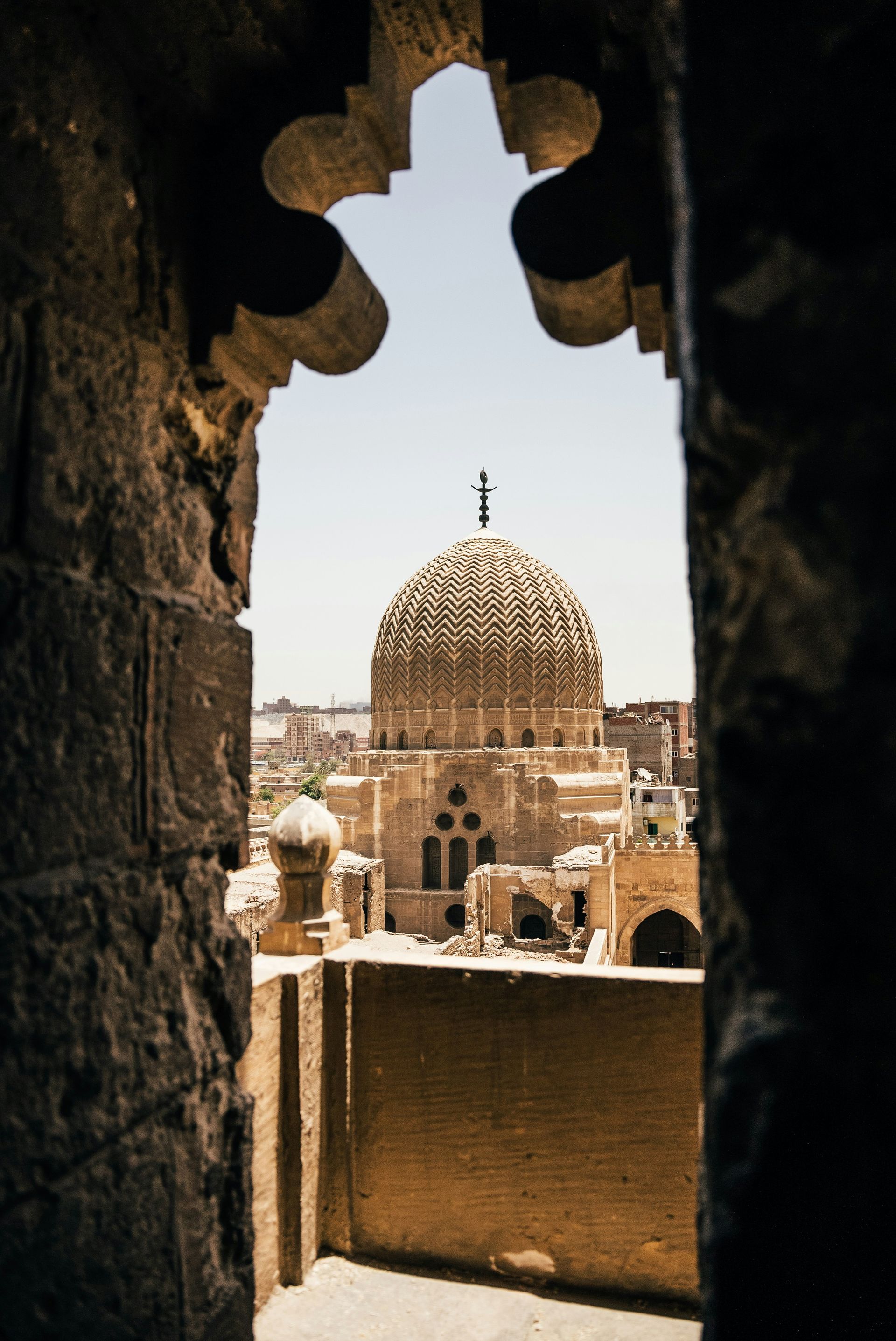 A view of a mosque through a stone archway in Cairo, Egypt.