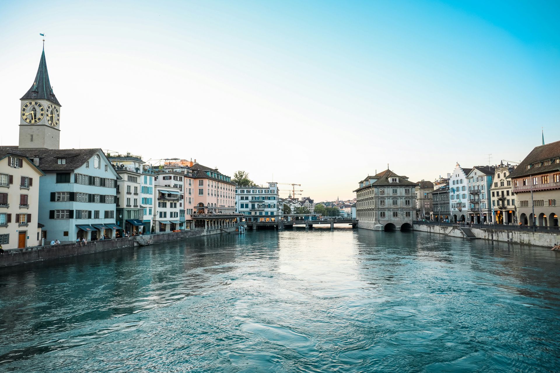 Zurich, Switzerland: River Limmat flows through the city, with historic buildings and a clock tower in view.