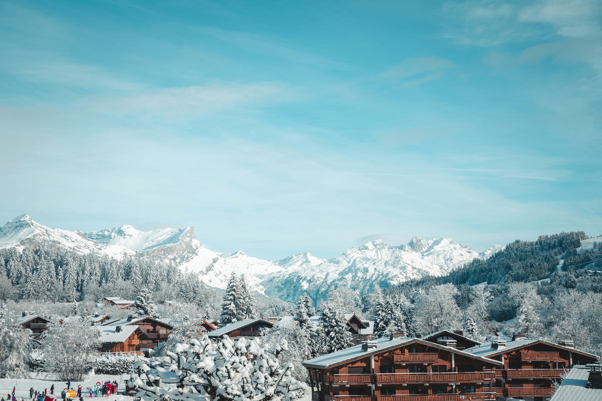 A ski resort with a lot of snow on the ground and the French Alps in the background in Megève, France.