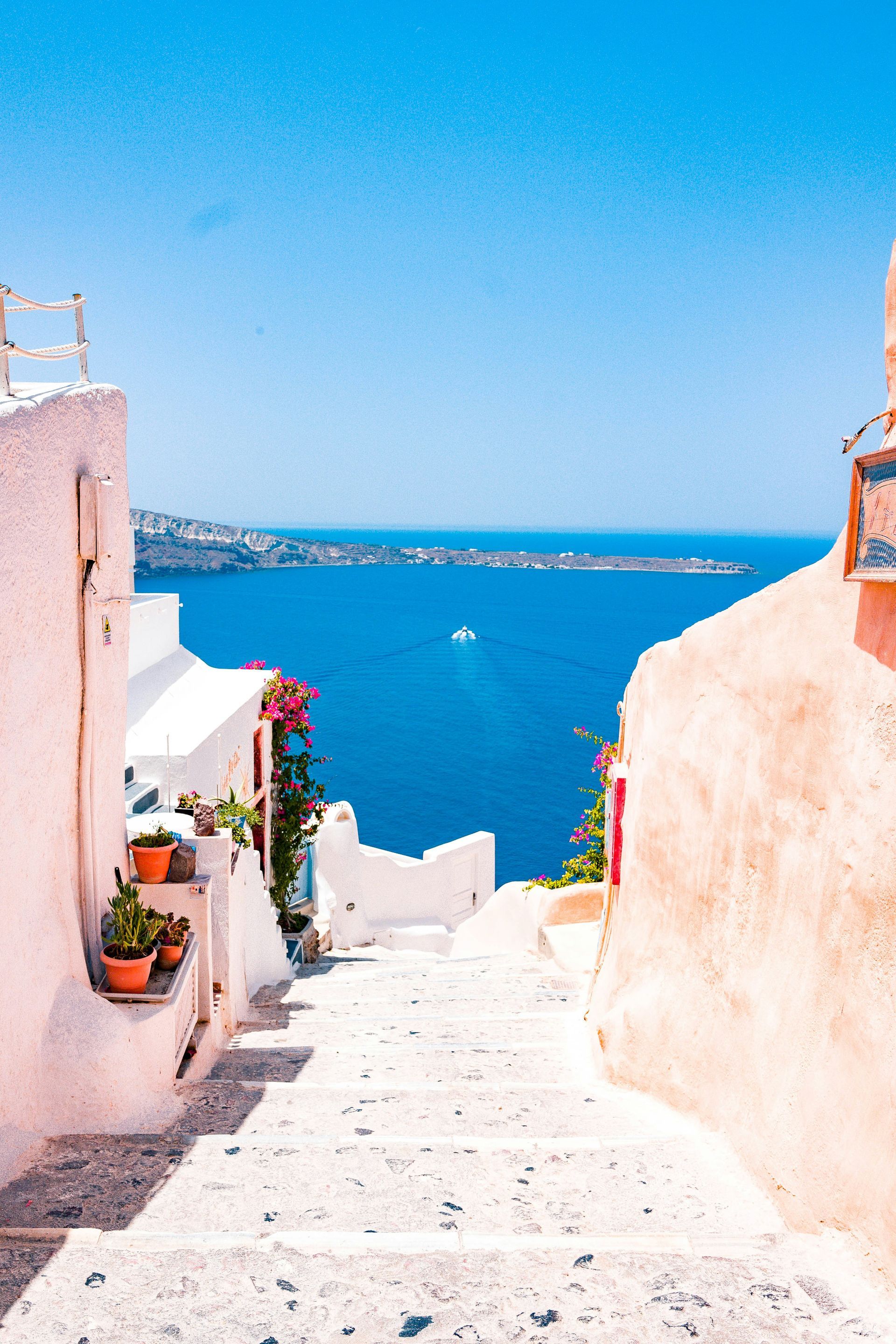 A set of stairs leading up to the ocean in Santorini, Greece.