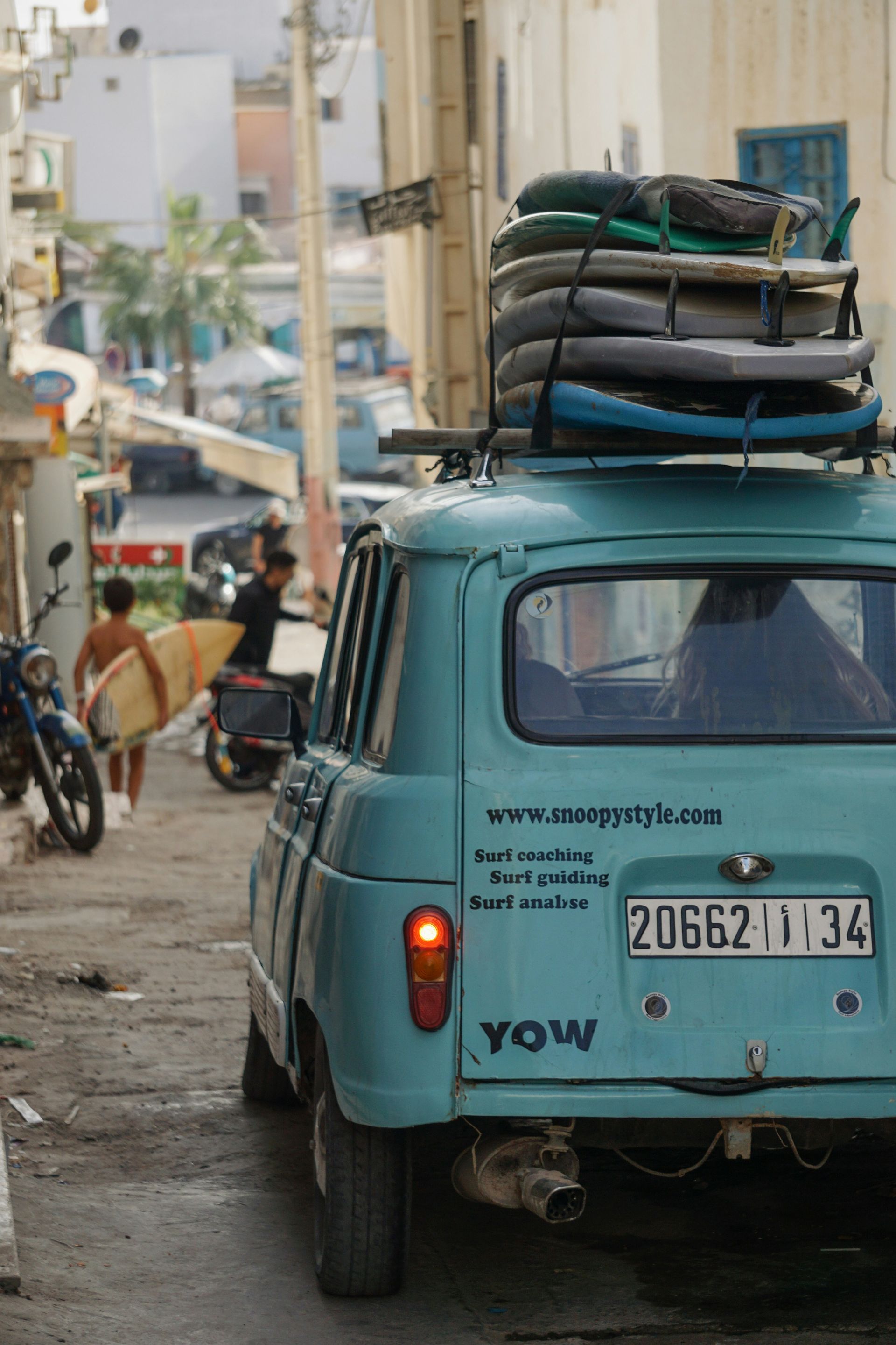 A blue tow truck with surfboards on top of it in Taghazout, Morocco.