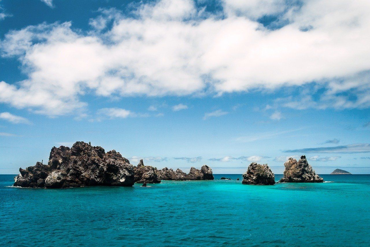 A group of rocks in the middle of the ocean in the Galapagos.