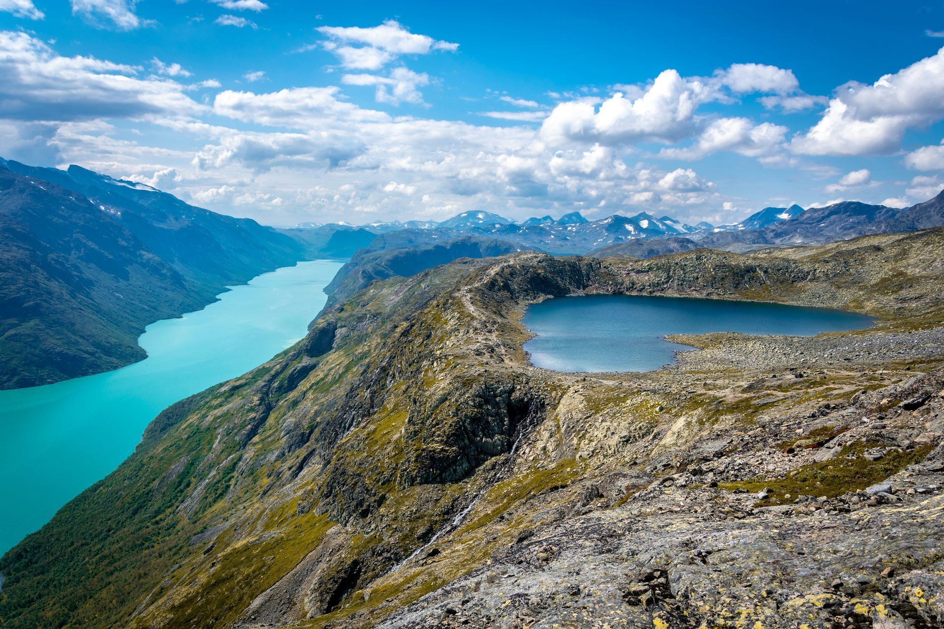 Mountain landscape with turquoise lake, small blue lake in Jotunheimen National Park, Norway.