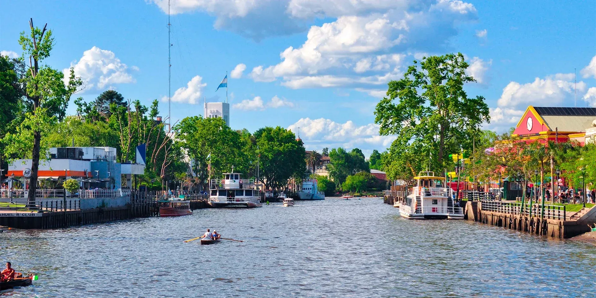 A river with boats and trees on the side of it