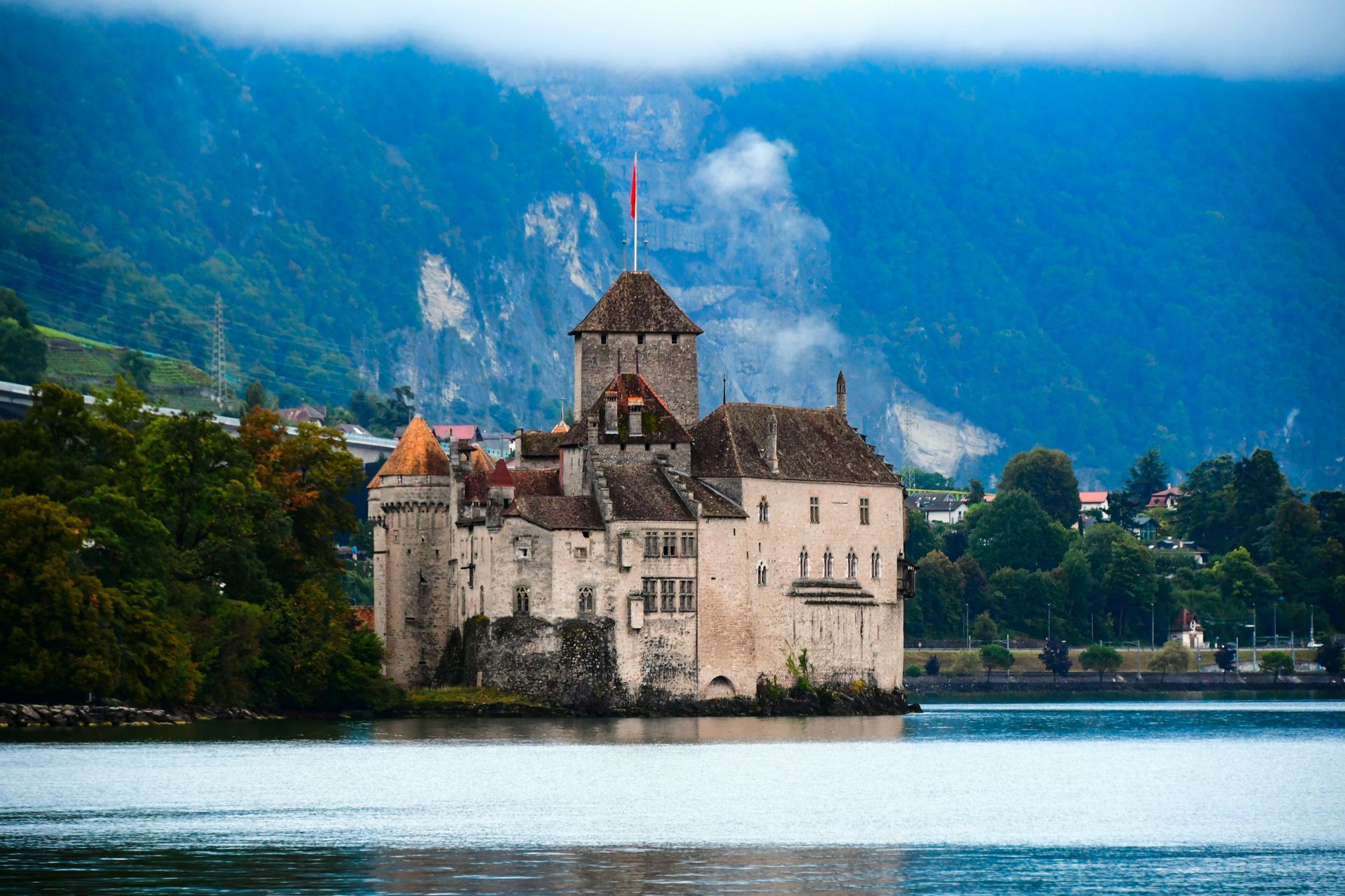 Medieval Chillon Castle on Lake Geneva, Switzerland, with mountains in the background in Montreux, Switzerland.