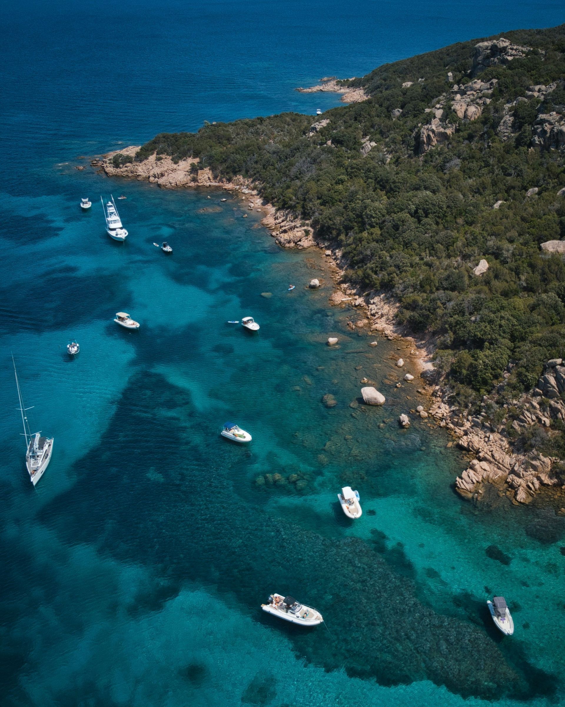 An aerial view of a body of water with boats in it in Corsica, France.