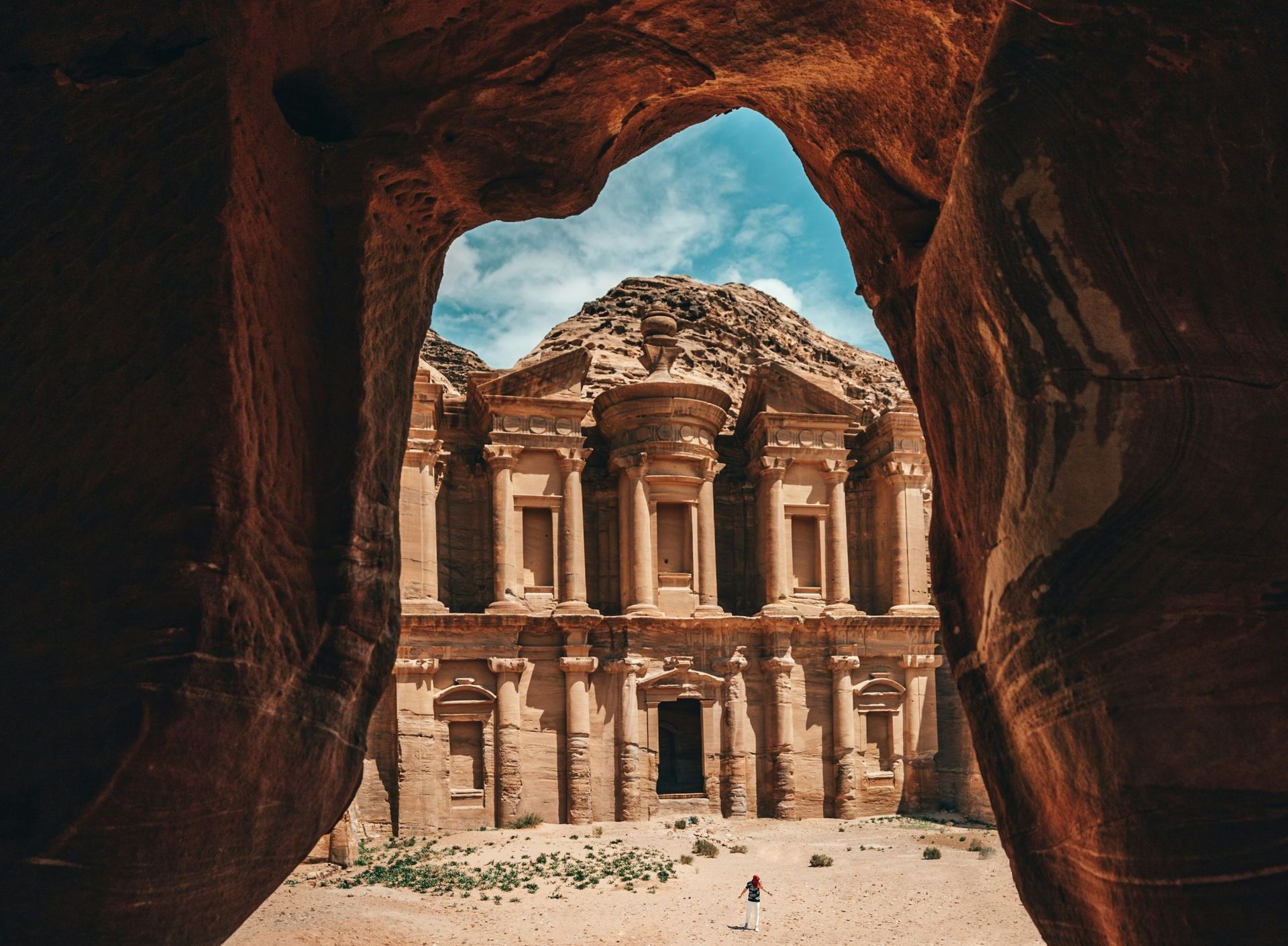 A view of a building through a cave in the desert of Jordan.