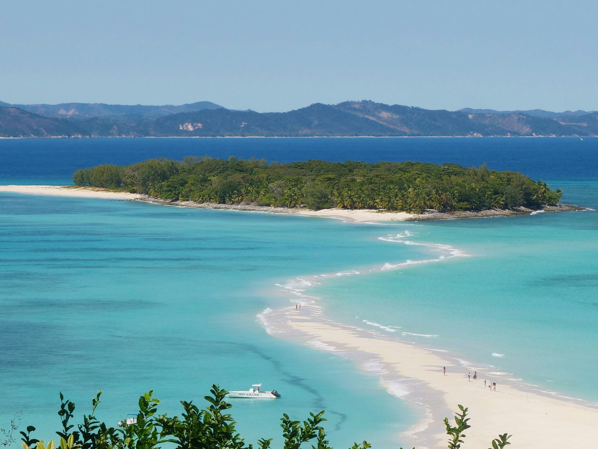 Nosy Iranj Island with white sandbar, turquoise water, and lush green trees in Madagascar.