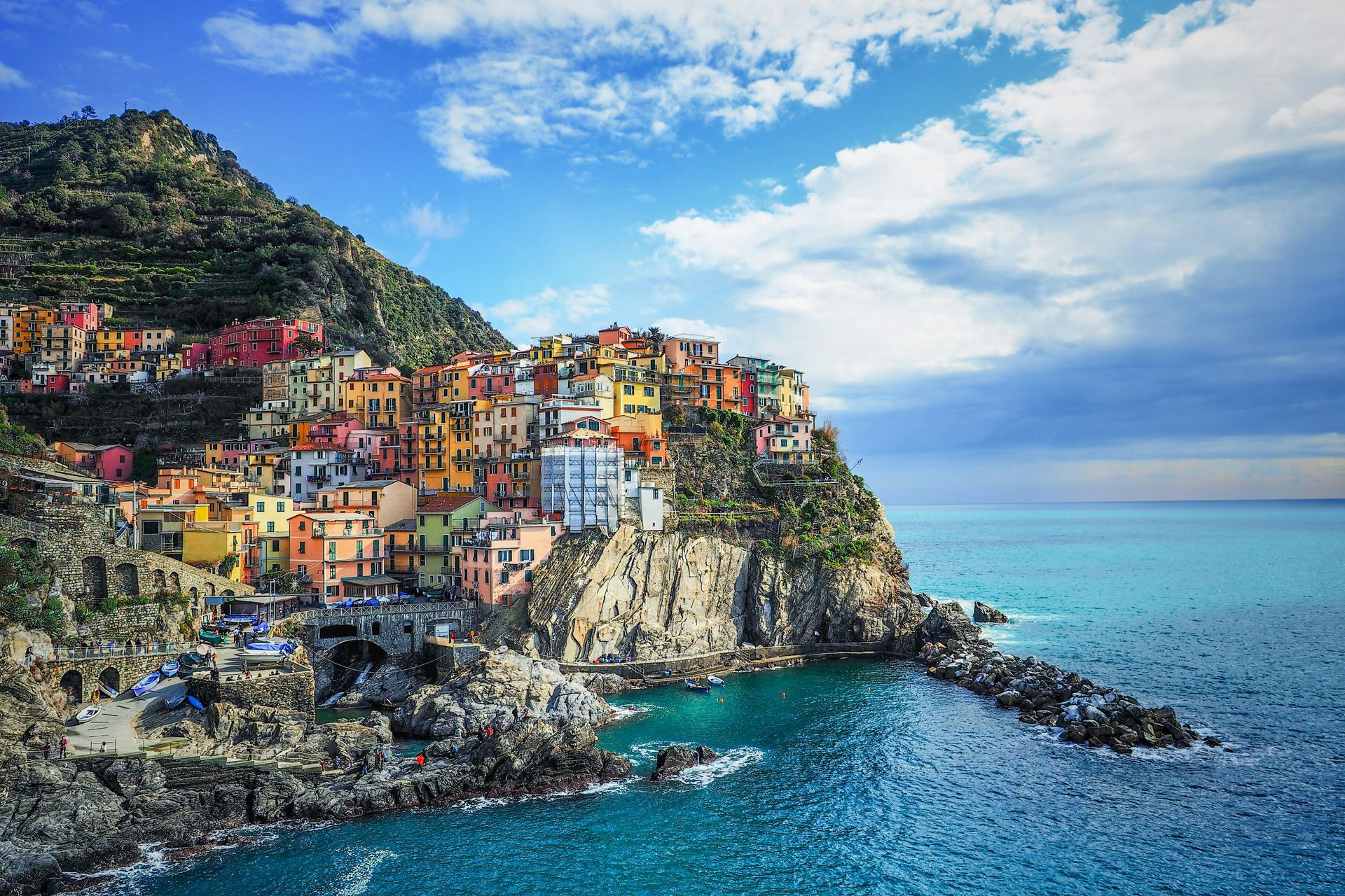 A small town is on a cliff overlooking the ocean in Cinque Terre, Italy.