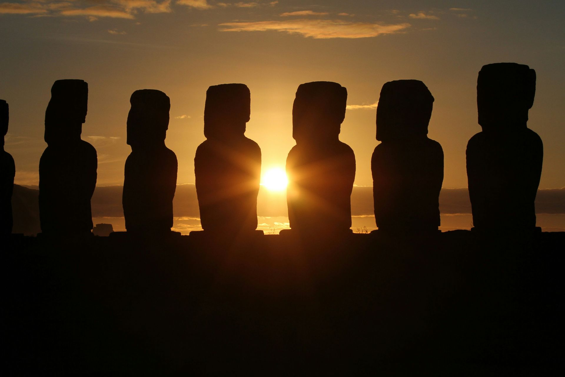 Silhouette of moai statues at sunset, Easter Island.