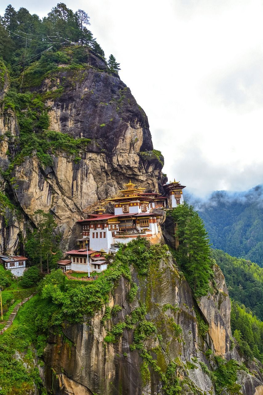 Tiger Nest Monastery is sitting on top of a cliff in the mountains in Bhutan.