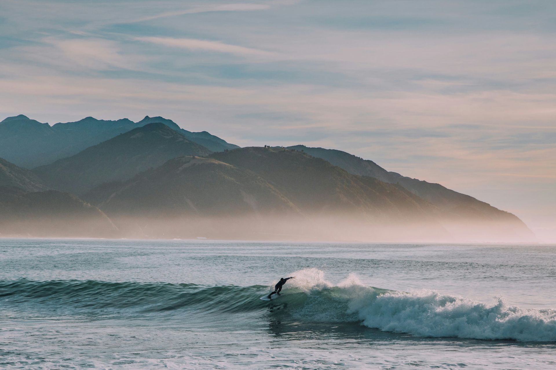A man is riding a wave on a surfboard in the ocean in Australia.