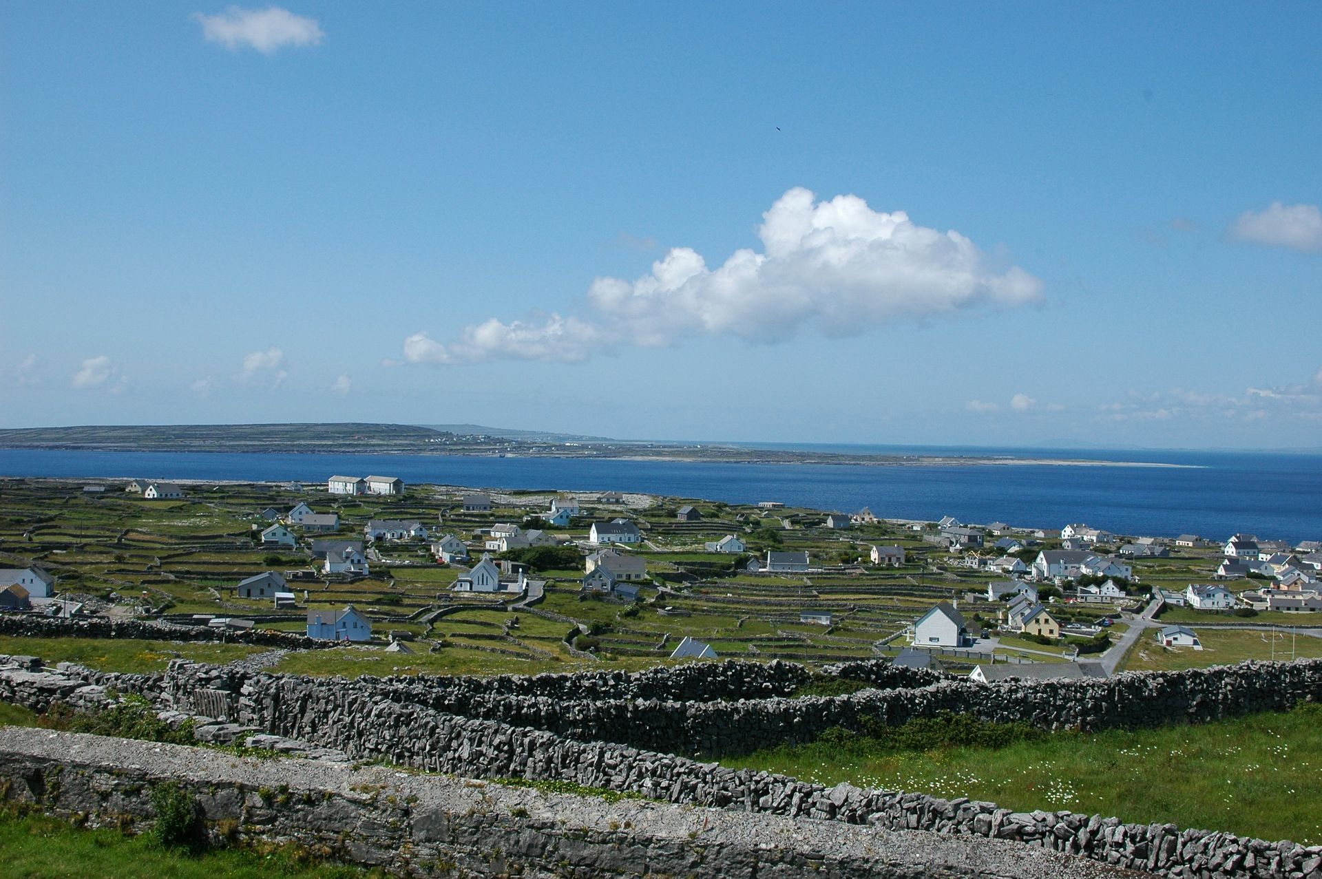 Houses and stone walls on an Irish island, with the ocean on the Aran Islands, Ireland.