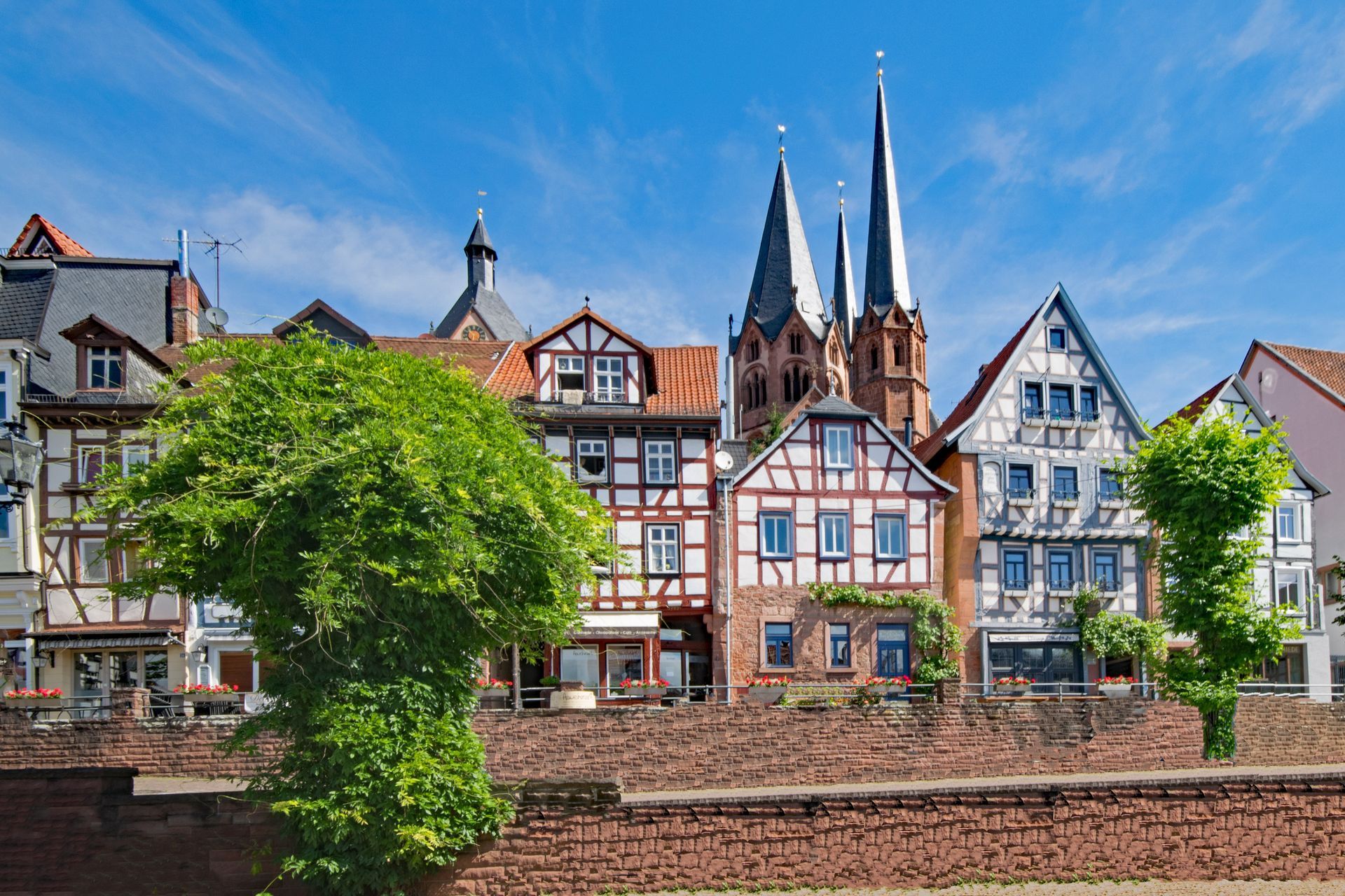 A row of houses with a church in the background in Gelnhausen, Germany.