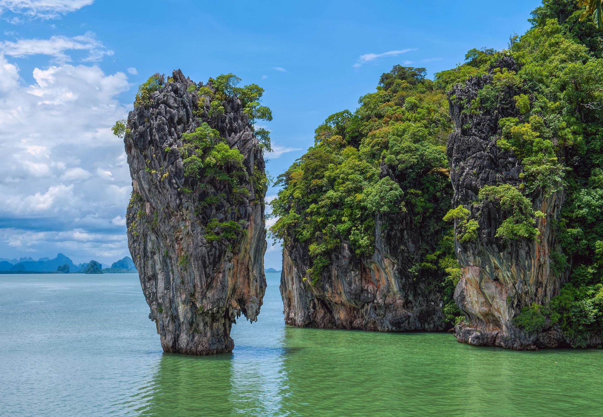 A group of rocks in the middle of a body of water in Phuket, Thailand.