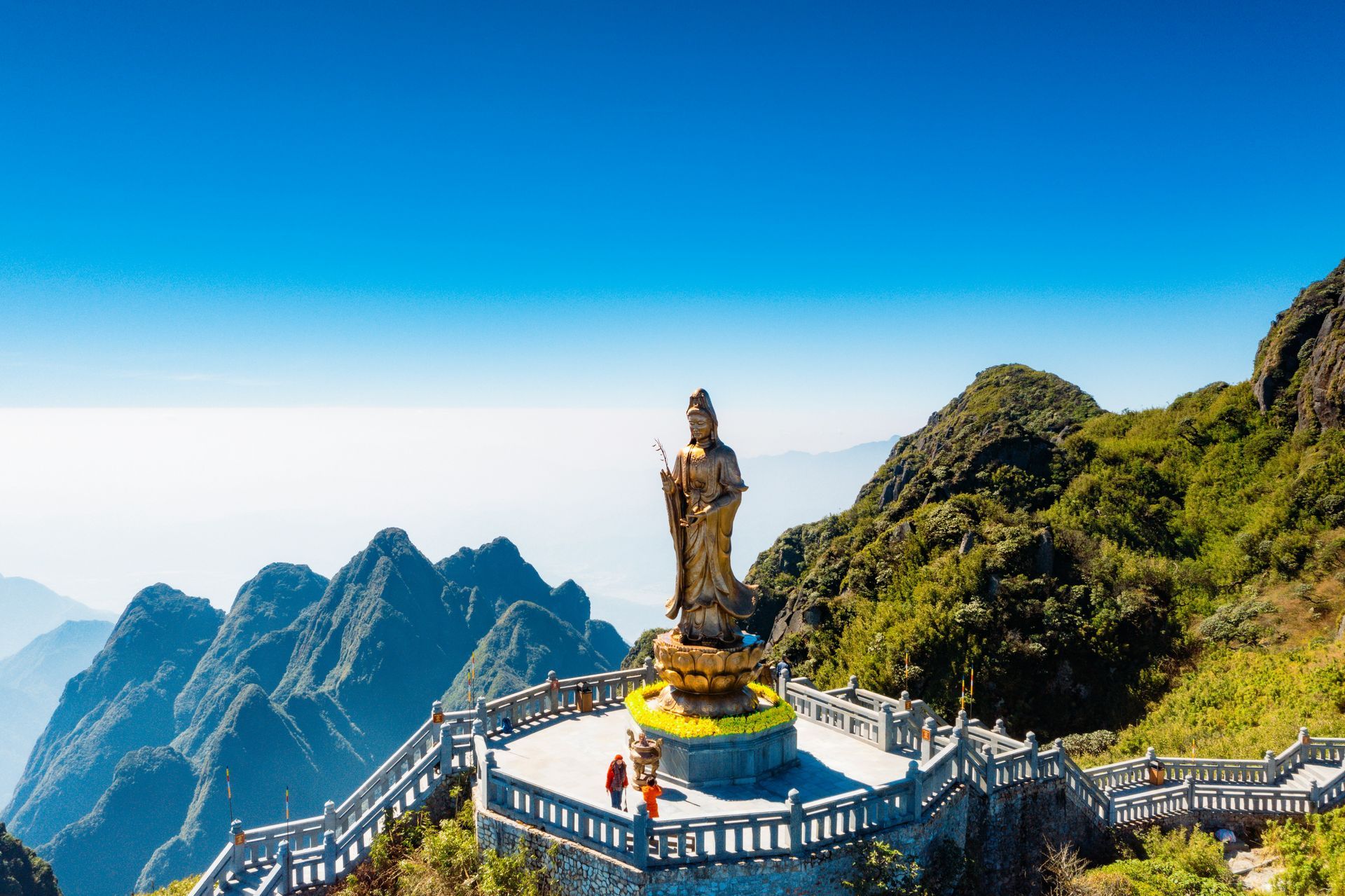 Statue of Buddha on mountain top overlooking scenic landscape in Sapa, Vietnam. 