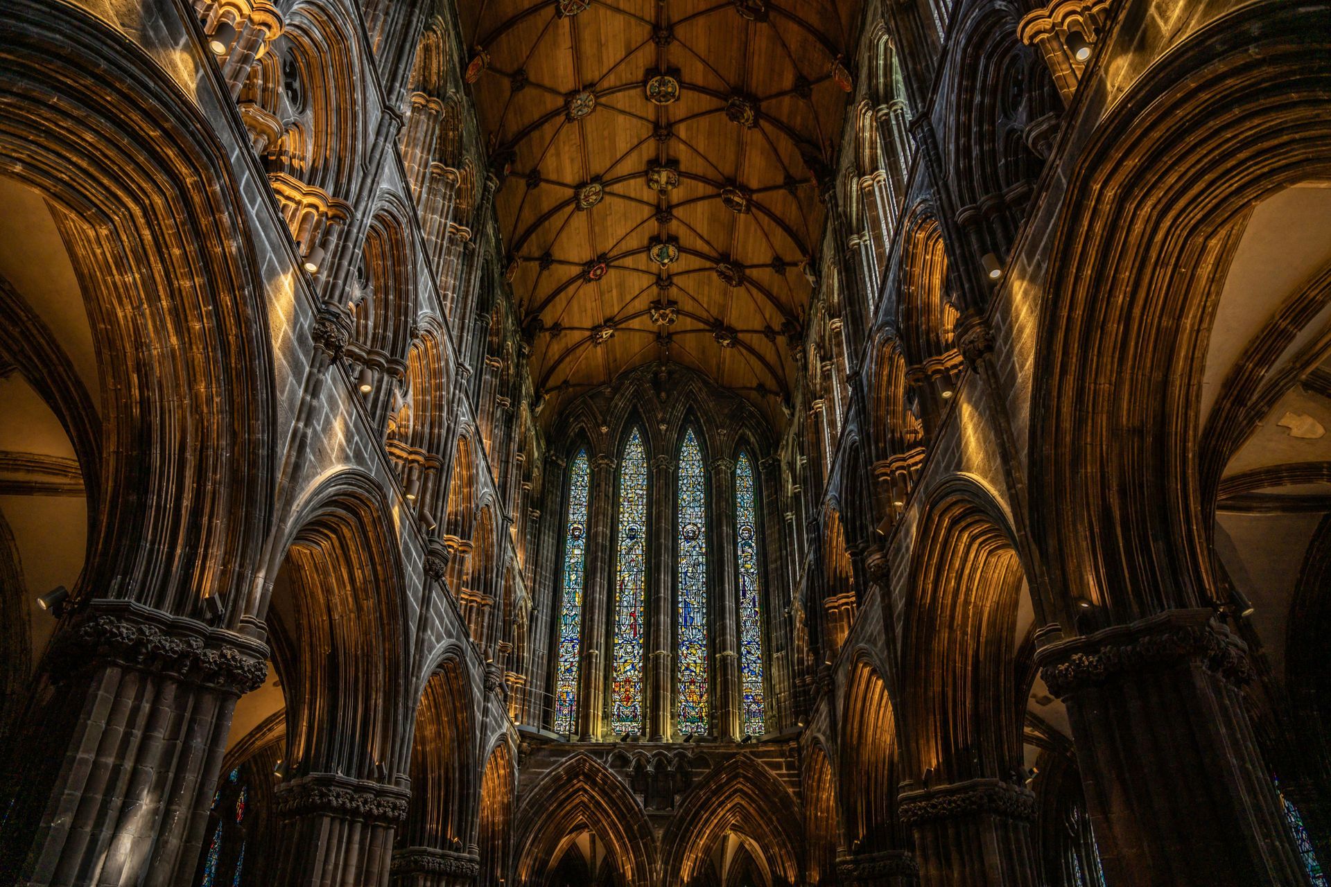 Interior view of the Glasgow Cathedral with arched ceiling and stained glass windows in Scotland.