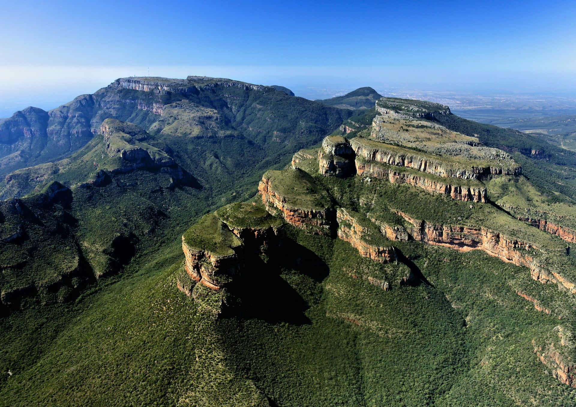 Green mountains, with visible rocky cliffs and vegetation, at Blyde River Canyon, South Africa.