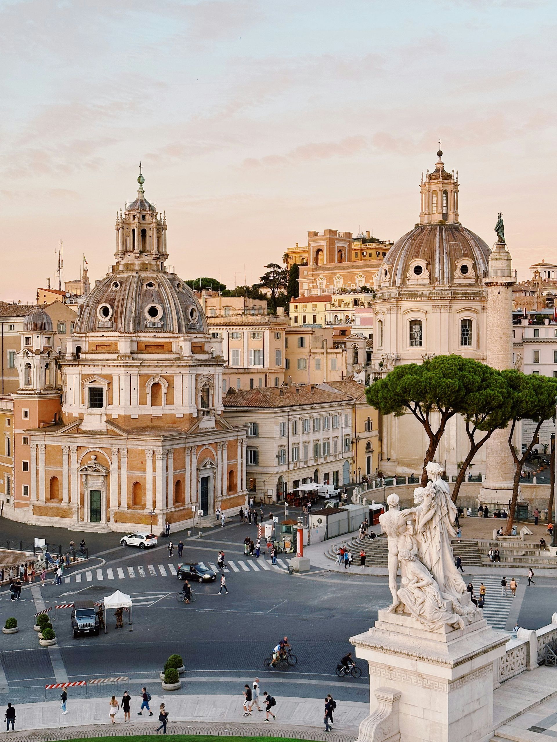An aerial view of a city with a statue in the foreground in Rome.