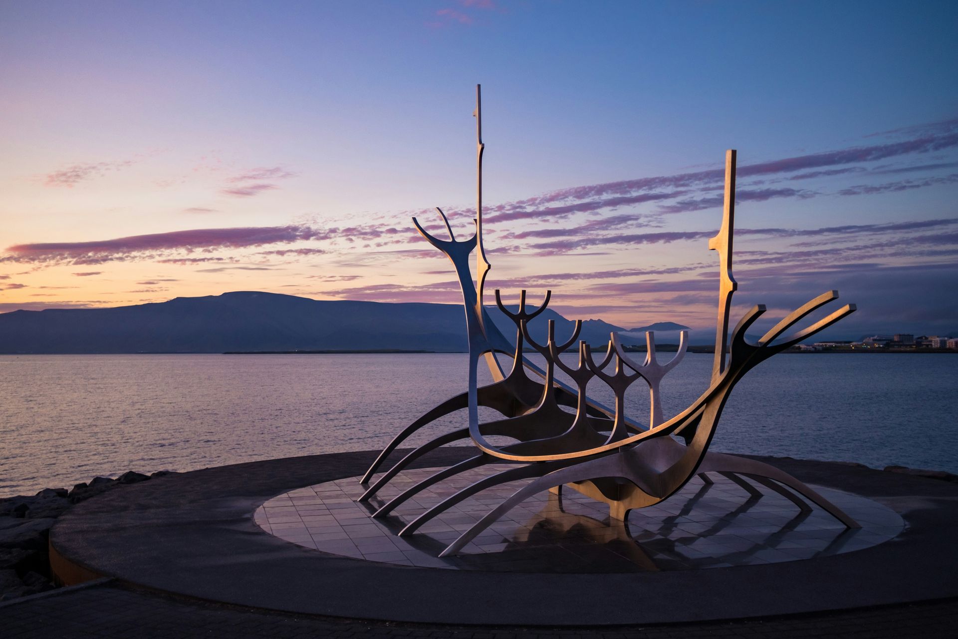 Stainless steel Sun Voyager sculpture at sunset, facing the sea in Reykjavík, Iceland.