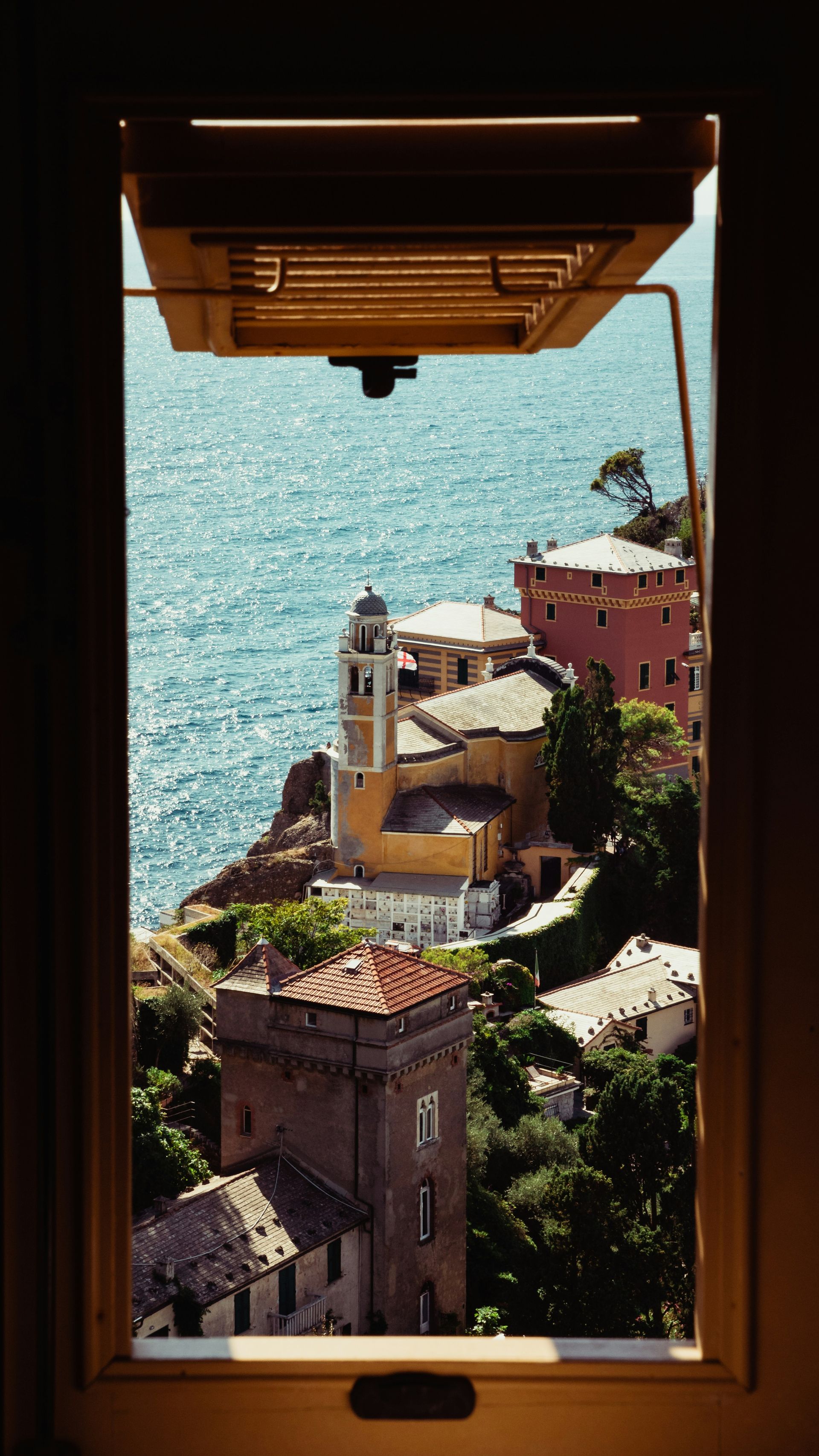 A view of Portofino, Italy from a window overlooking the ocean.