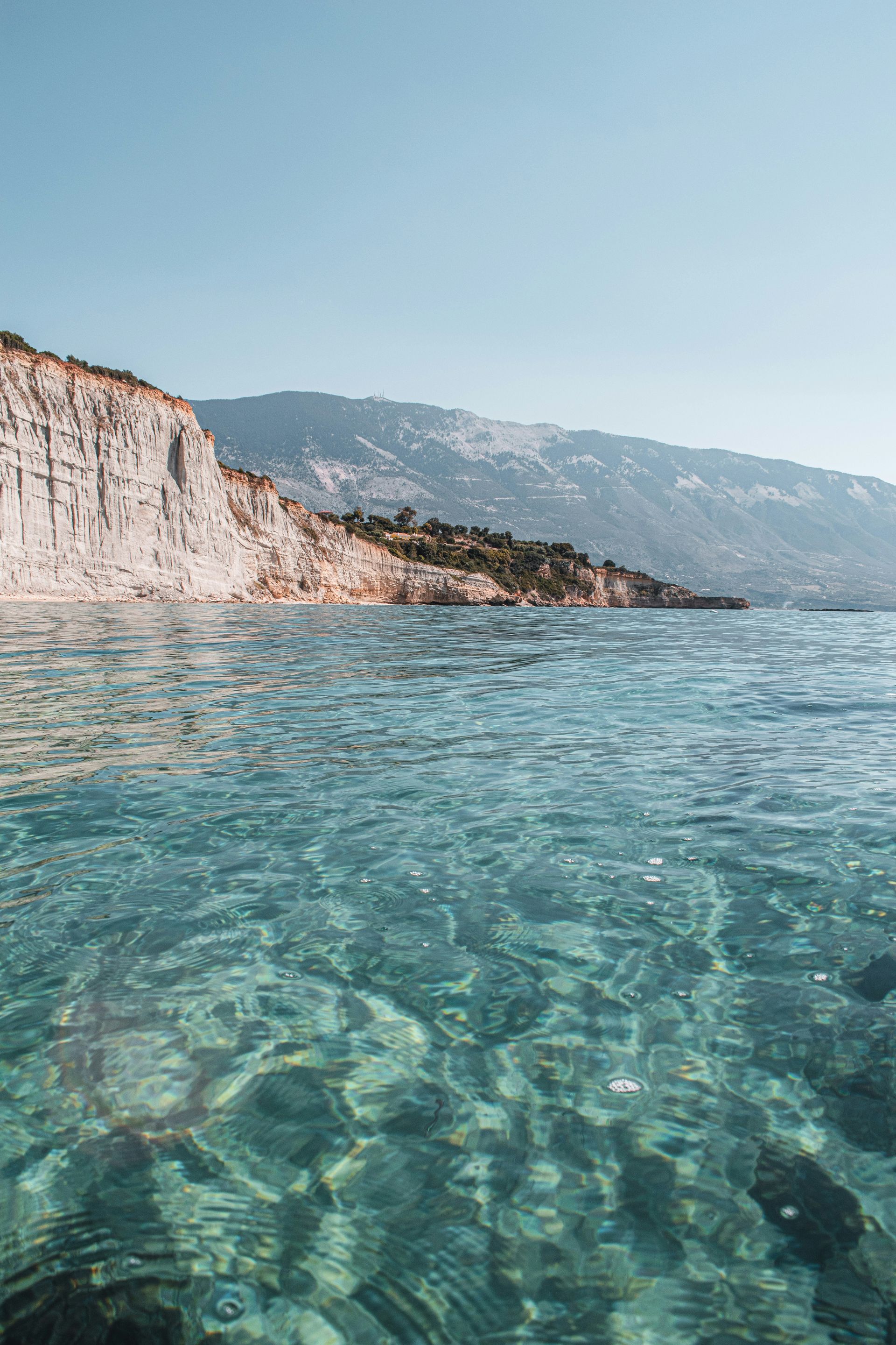 A view of a body of water with mountains in the background.