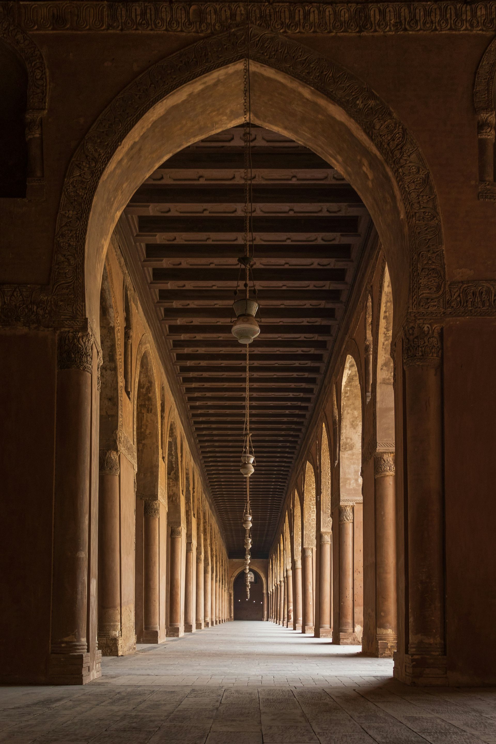 A long hallway with arches and columns in a building in Cairo, Egypt.