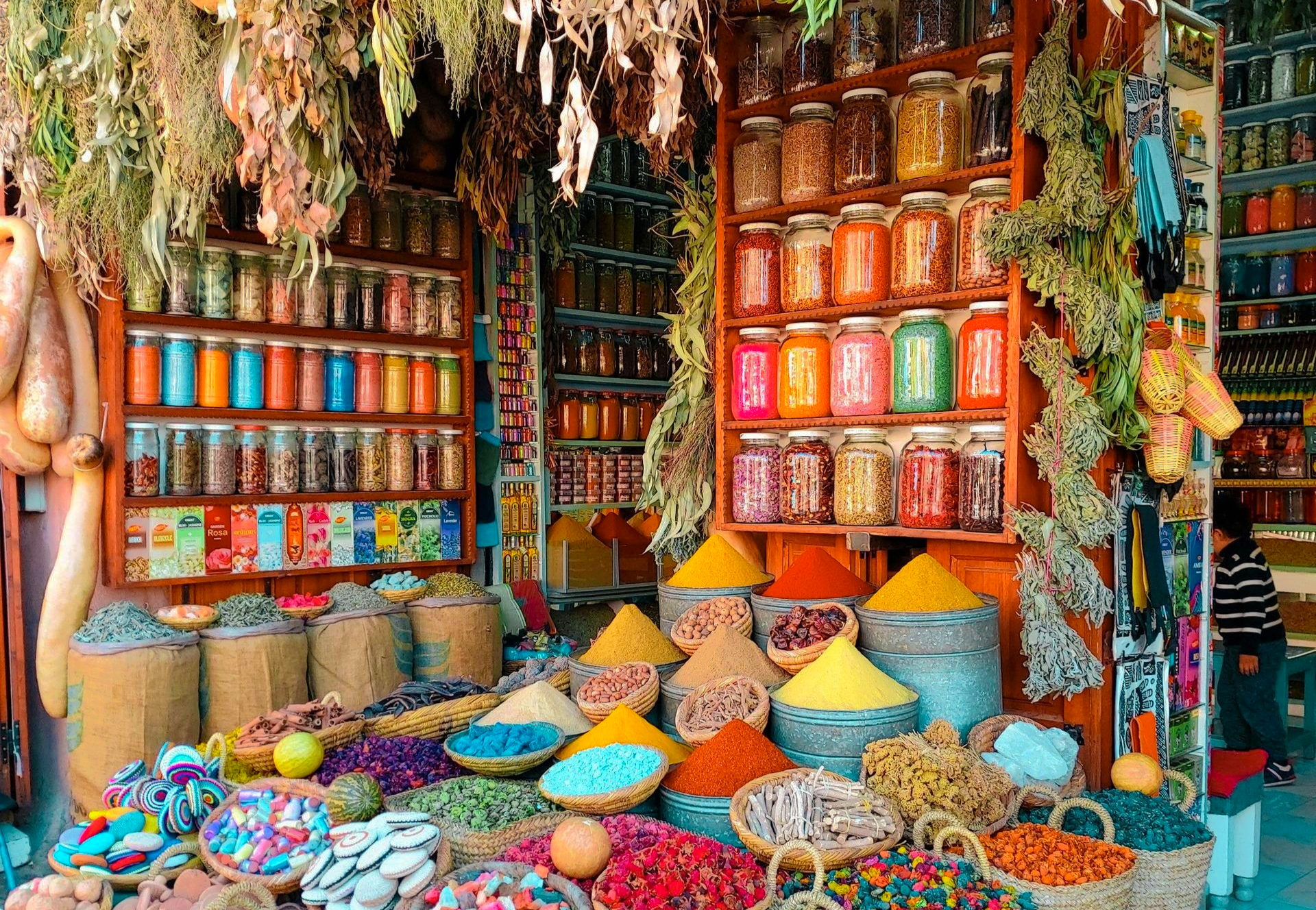 A store filled with lots of jars and baskets of spices in Morocco.