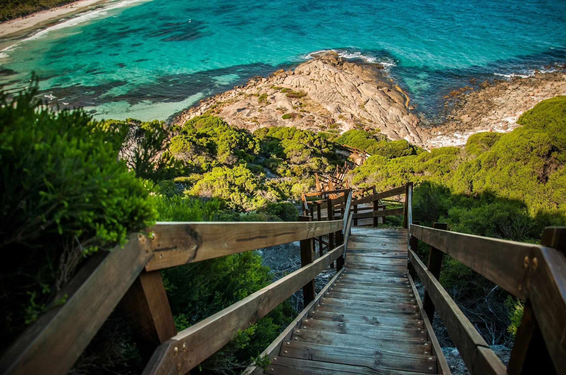 There is a wooden bridge leading to the ocean in Western Australia.