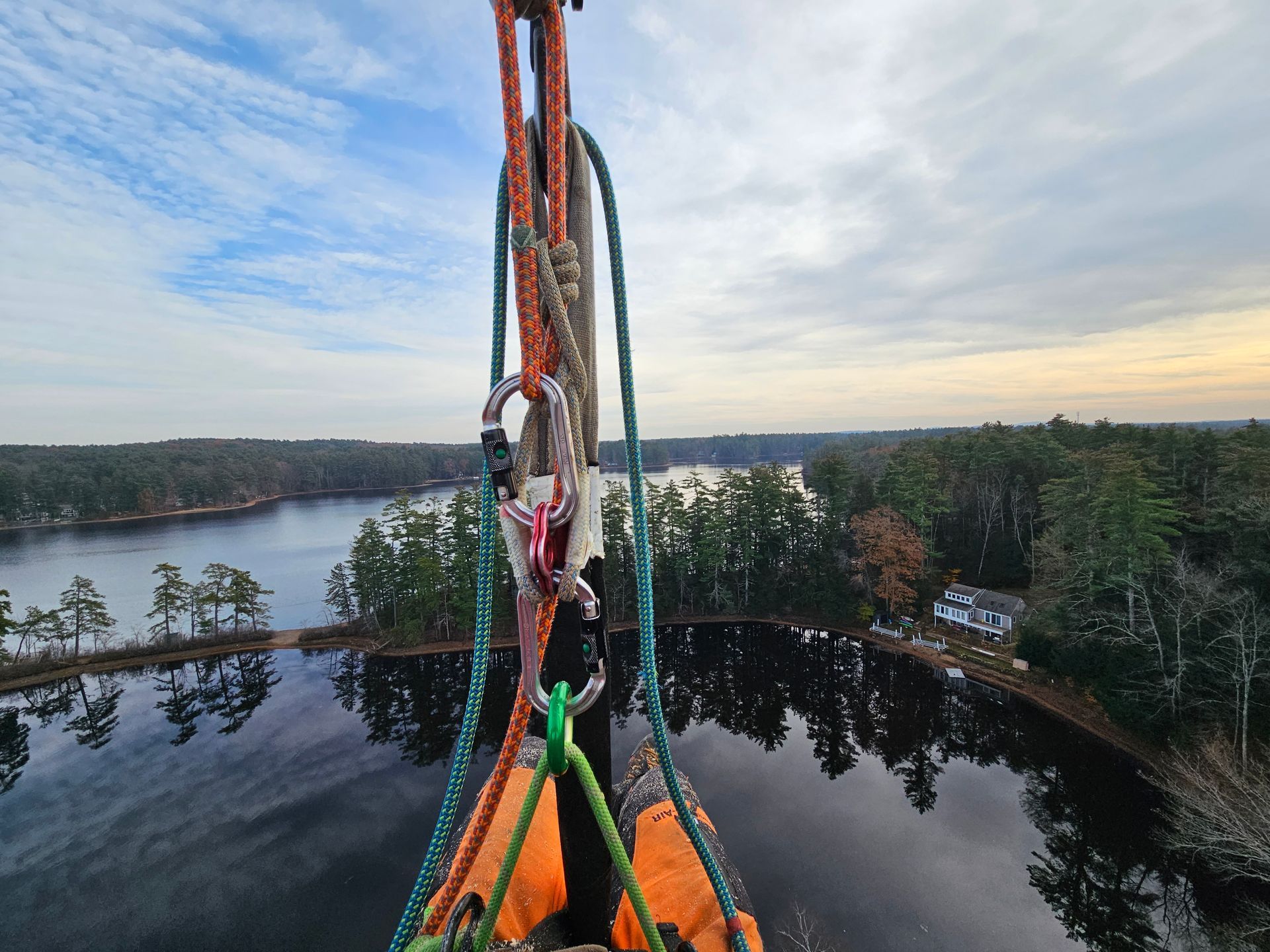 A person is hanging from a rope over a body of water.