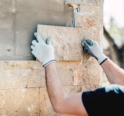 Brick Work — Construction Worker Installing A Decorative Stone in Phoenix, AZ