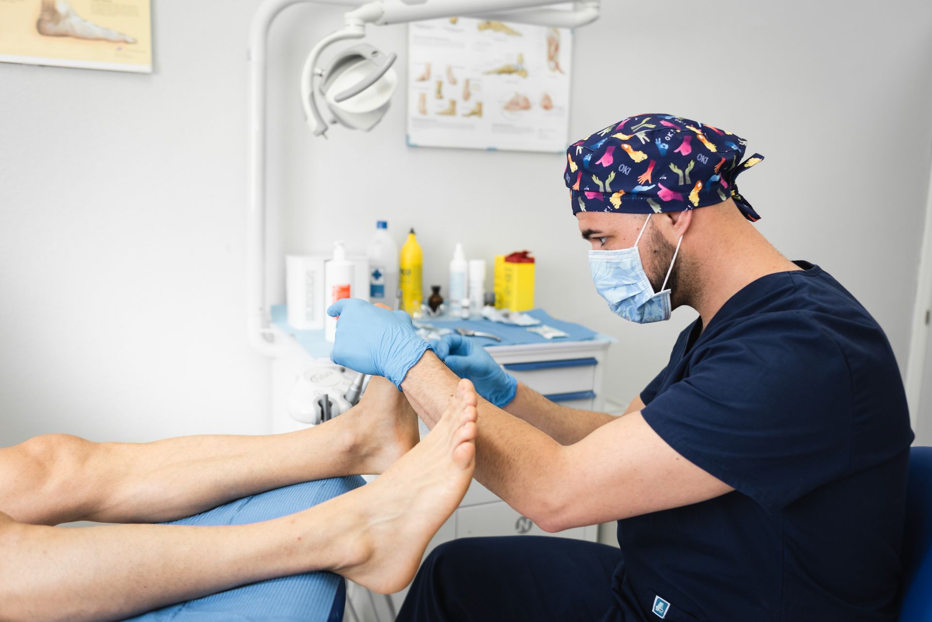 Podiatrist cutting toenails using sterile tools with podiatry surgical supplies for foot care.