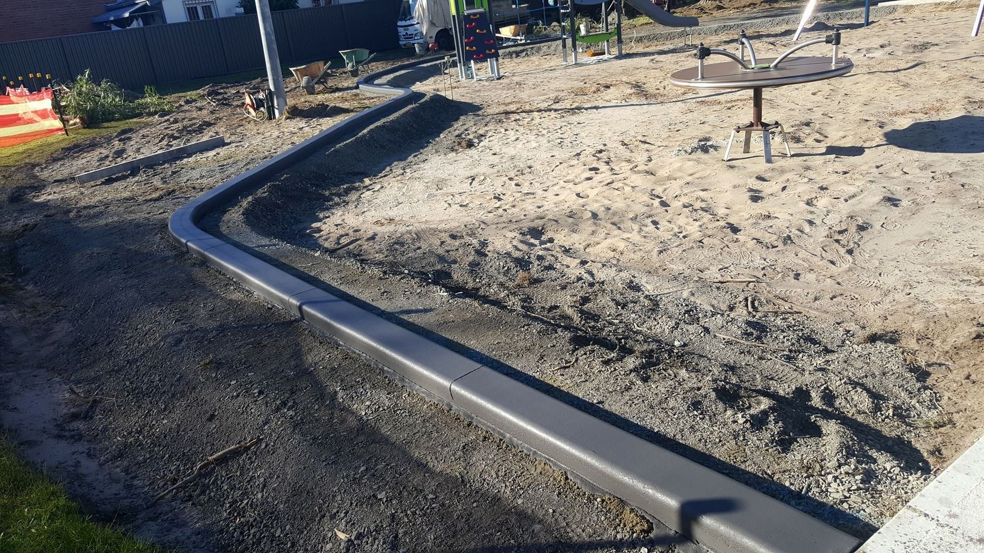 A concrete walkway is being built in a park