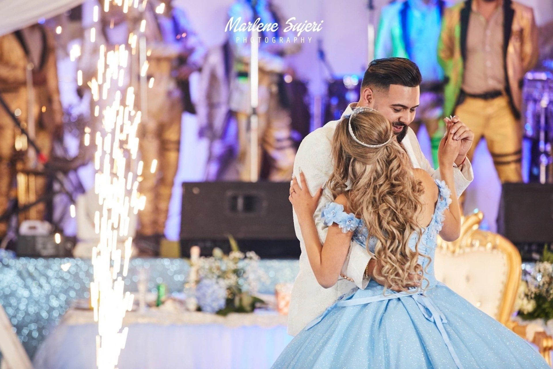 A bride and groom are sitting next to each other on a wooden deck.