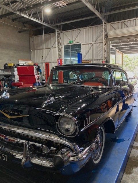 A Gearbox Is Sitting On A Table Next To A Hammer — Bay City Quality Mobile Mechanic In Pialba, QLD