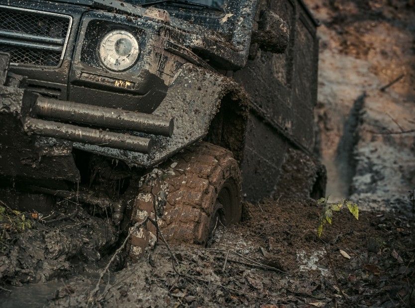 A Black Jeep Is Stuck In The Mud — Bay City Quality Mobile Mechanic In Pialba, QLD