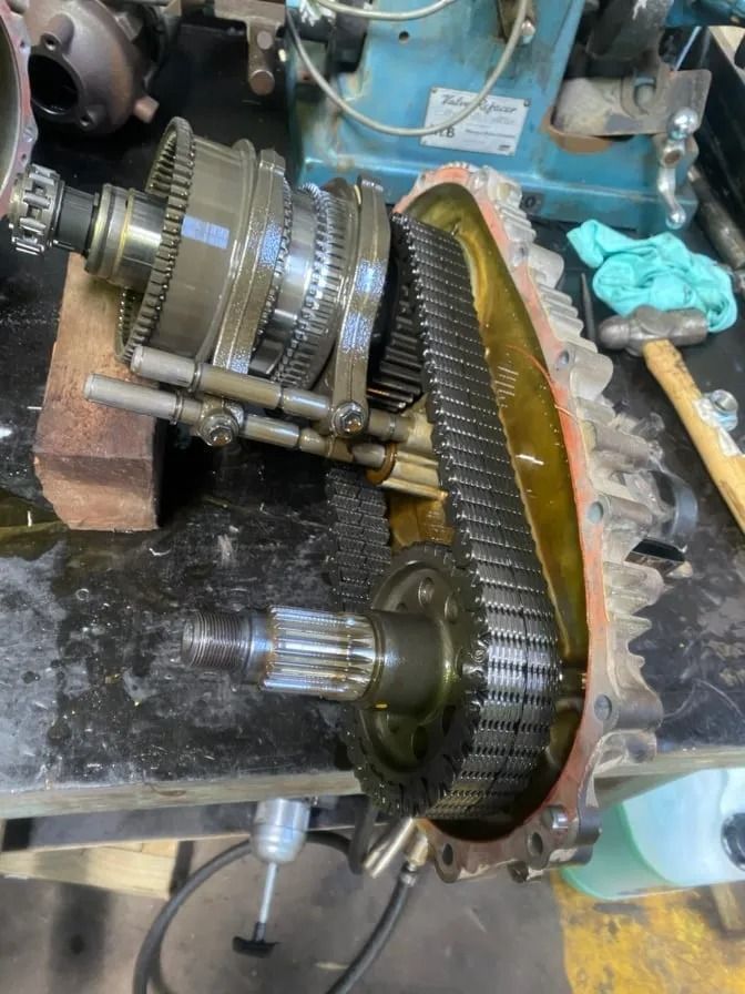 A Gearbox Is Sitting On A Table Next To A Hammer — Bay City Quality Mobile Mechanic In Pialba, QLD