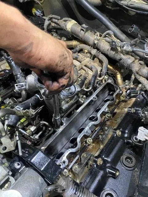 A Person Is Working On A Car Engine With A Wrench — Bay City Quality Mobile Mechanic In Pialba, QLD
