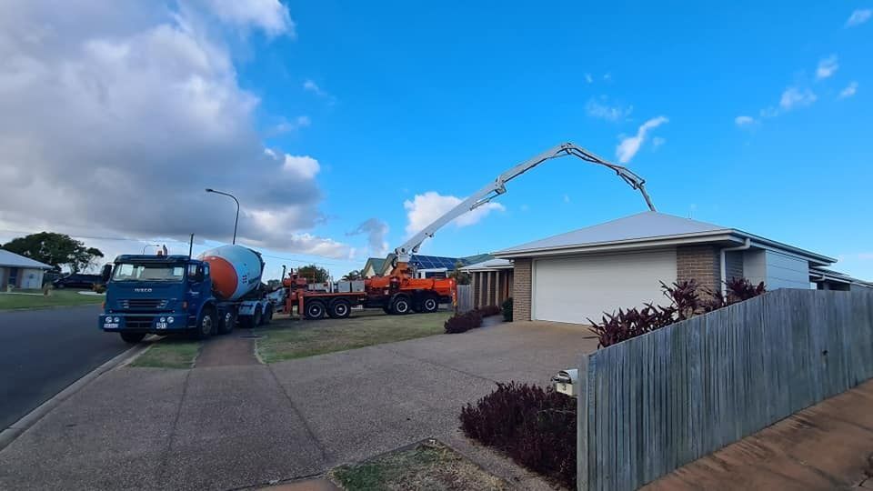 A Concrete Pump Is Being Used To Pour Concrete Into A House — Bushman Sheds in Bundaberg East, QLD