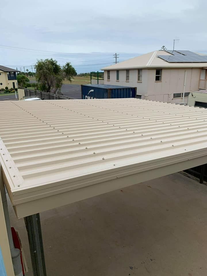 A Carport With A Roof That Looks Like A Roof Of A Shed — Bushman Sheds in Bundaberg East, QLD