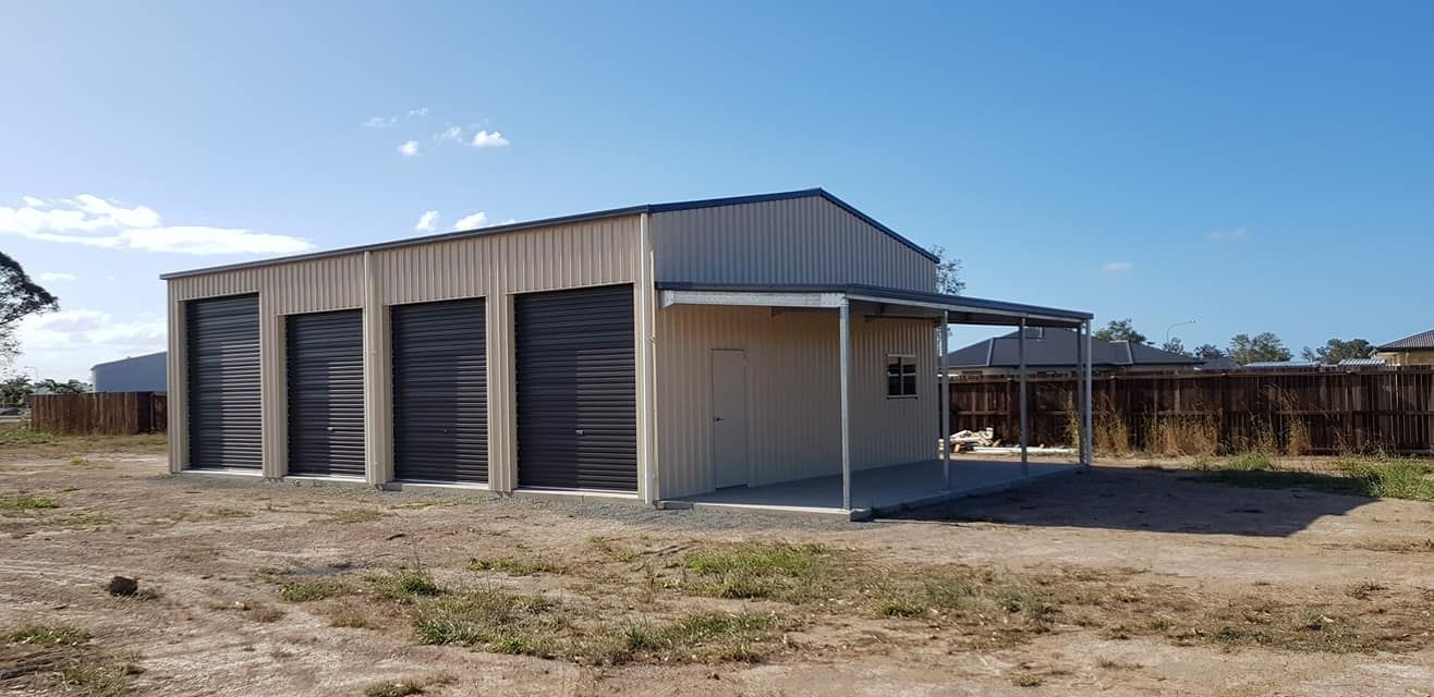 A Small Shed With A Porch Is Built In The Middle Of A Dirt Field — Bushman Sheds in Bundaberg East, QLD