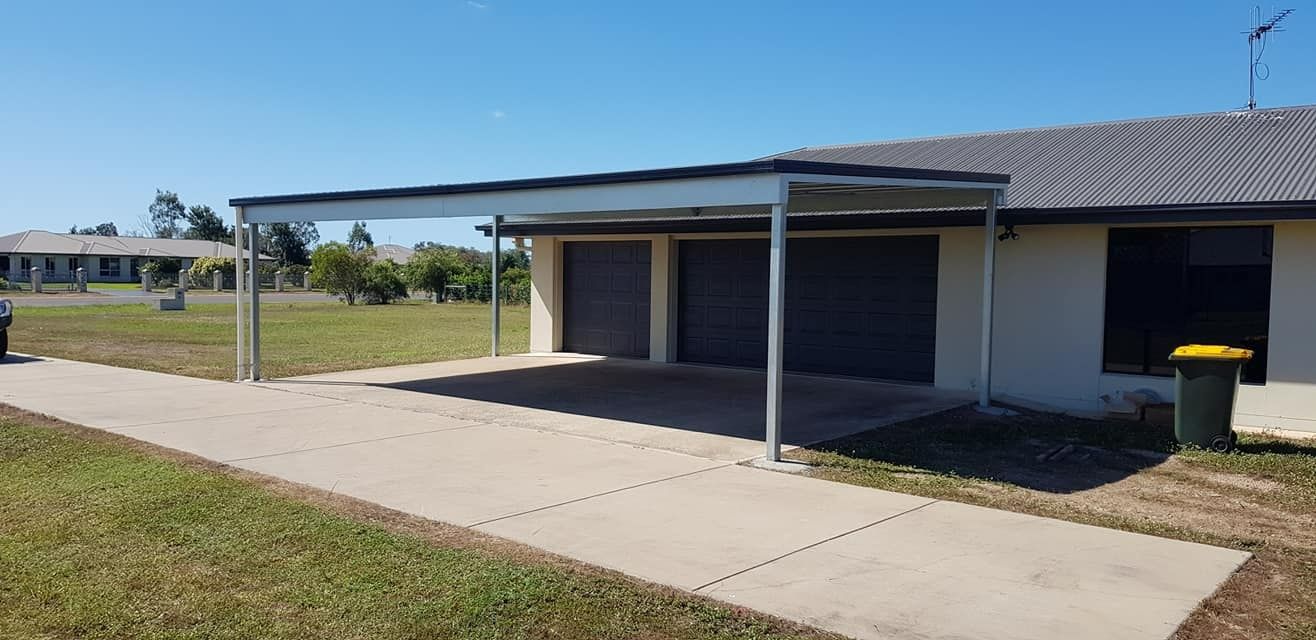 A Metal Shed House With A Carport In Front Of It — Bushman Sheds in Bundaberg East, QLD