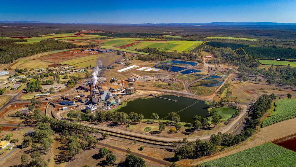 An Aerial View Of A Sugar Refinery Surrounded By Fields And Trees — Bushman Sheds in Childers, QLD