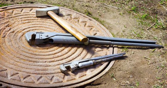 Tools on a sewer cover