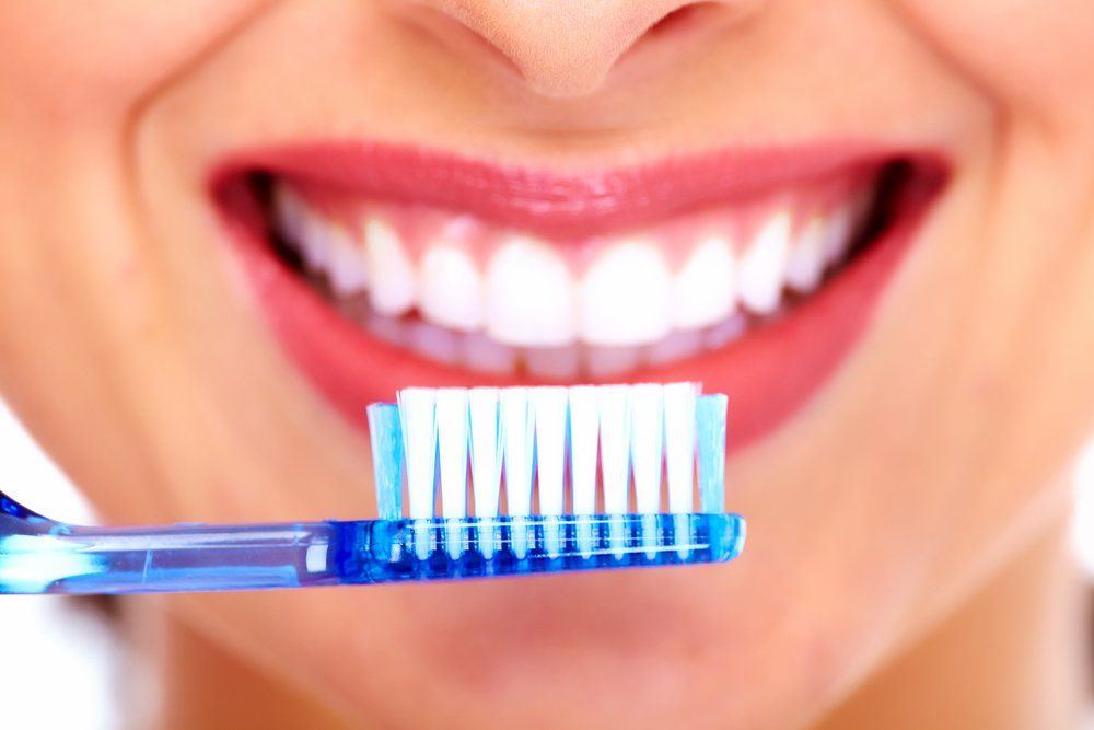White Smile And Toothbrush — Dentistry Services in Cairns, QLD