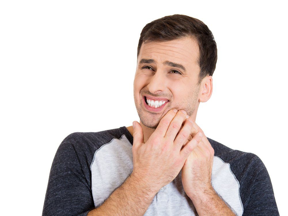 Man With Very Bad Tooth Ache — Dentistry Services in Cairns, QLD