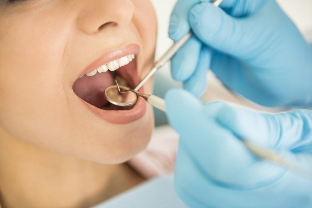 Dentist Examining A Patient's Teeth — Dentistry Services in Cairns, QLD