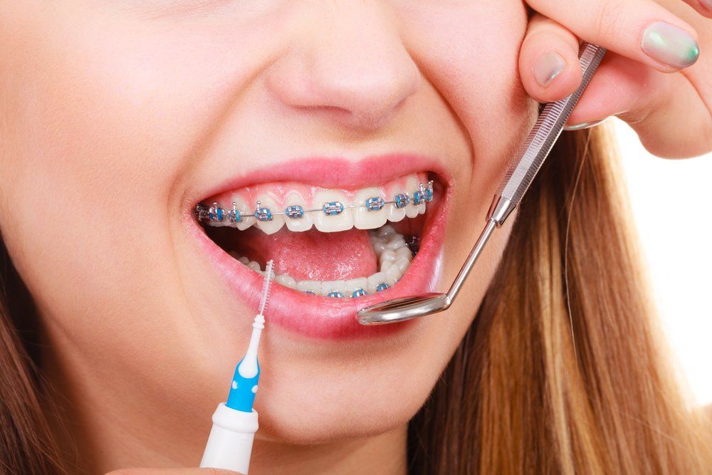 Woman With Braces Having Dentist Appointment — Dentistry Services in Cairns, QLD