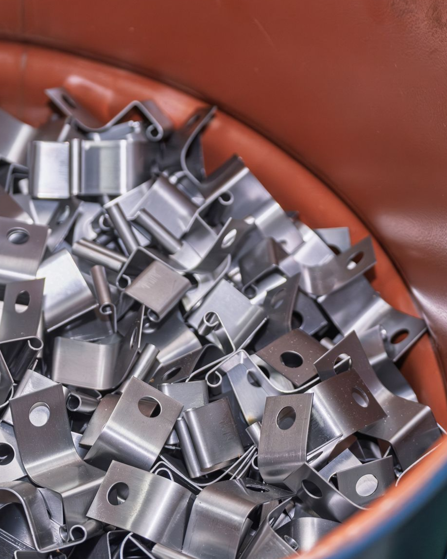 Metal brackets in a container; close-up view.