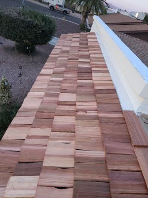 The roof of a house is made of wooden tiles.